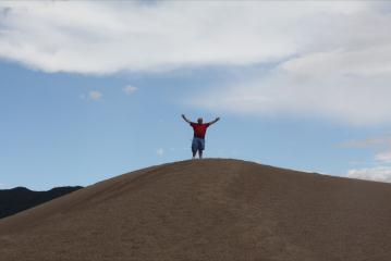 Ian gets to the top of one dune