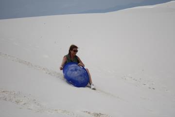 Nancy sledding at White Sands